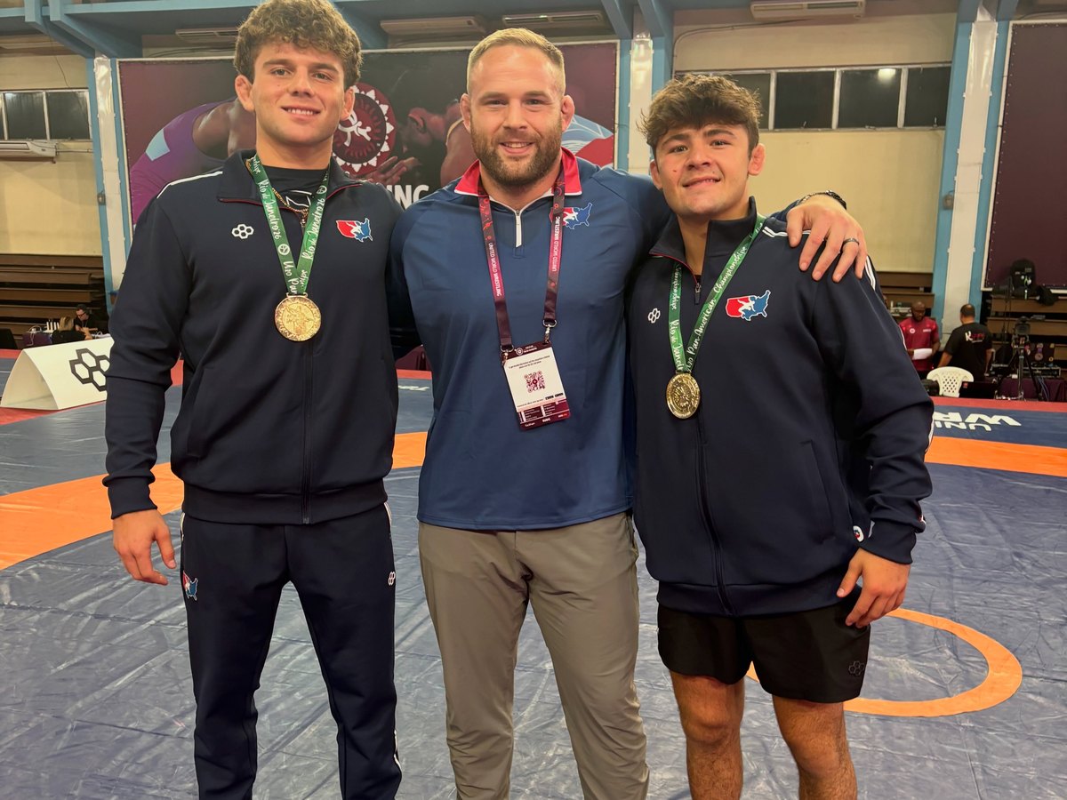 Club athletes with their coach after medaling at the U20 World Championships