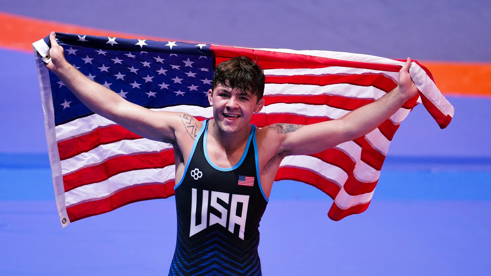 Bo Bassett celebrating his U20 World title with the American flag in Bratislava